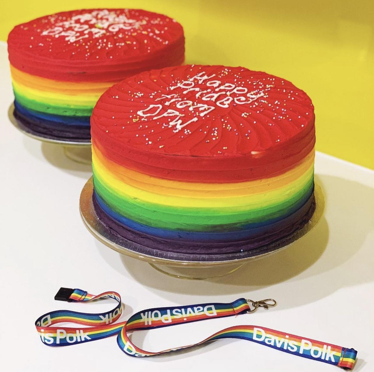 Rainbow-colored cakes with Happy Pride from DPW written in frosting